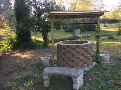 The final step of the wishing well. Wrapping muscadine vines around the posts. 